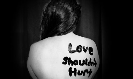 love shouldn't hurt-printed on back of woman