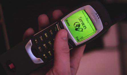a person holding a cell phone with a green screen