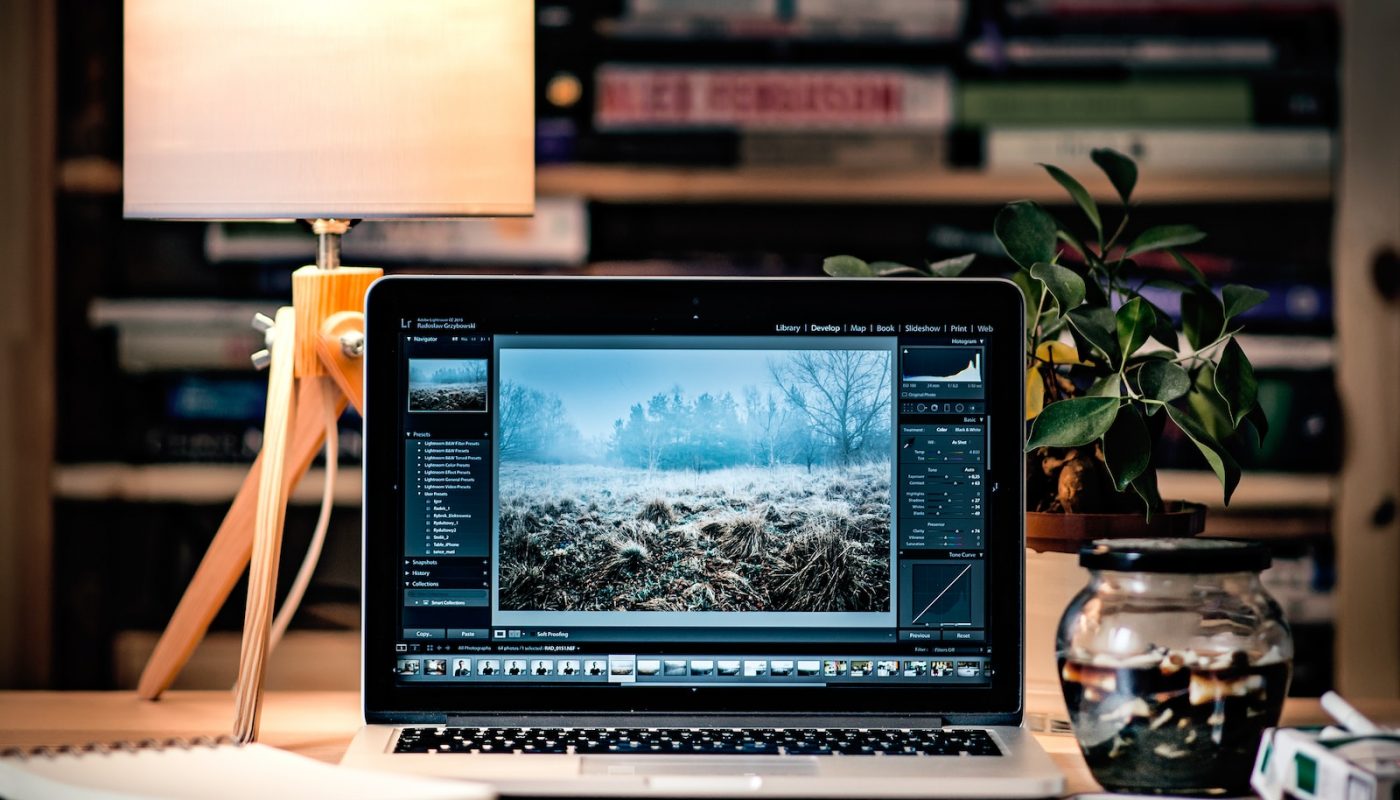 MacBook Pro on brown wooden table inside room